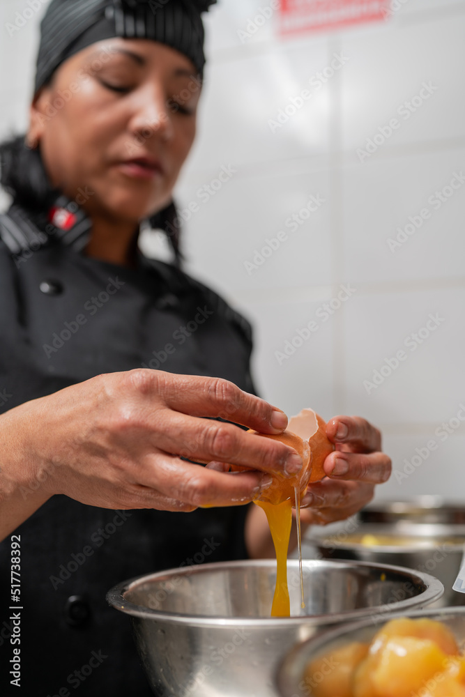 Black woman breaking egg in restaurant Stock Photo Adobe Stock