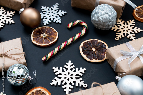 Beautiful Christmas golden silver decorations on a dark black background. Flat design, postcard, calendar, banner.