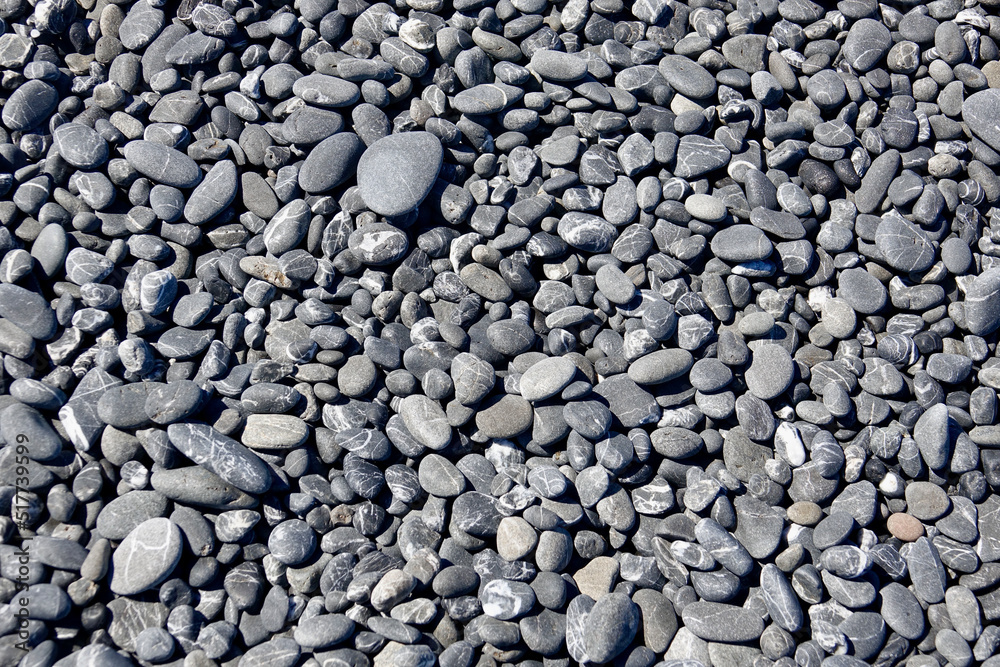 smooth black and gray pebbles on the beach smooth black and gray pebbles on the beach