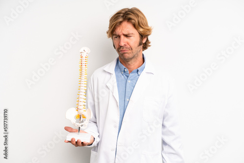 blond adult man feeling sad, upset or angry and looking to the side. physician or doctor concept photo