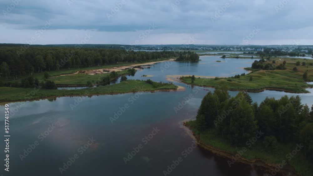 Aerial photography of people on sup boards on the river in the evening Aerial photography of people on sup boards on the river in the evening
