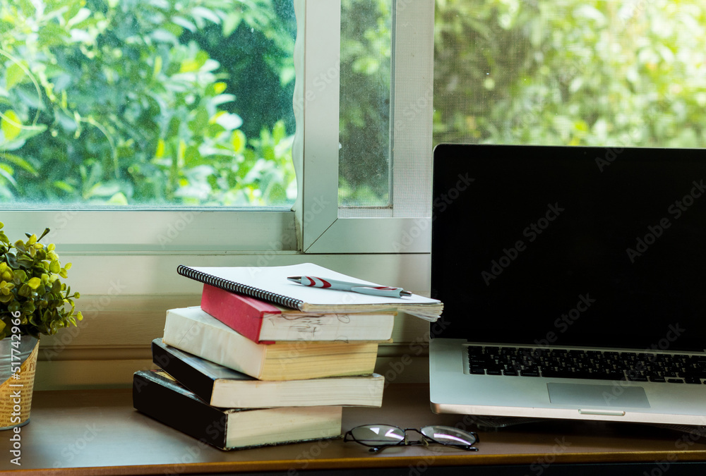 work area has a computer and potted plants natural green background.business nature concept work area has a computer and potted plants natural green background.business nature concept