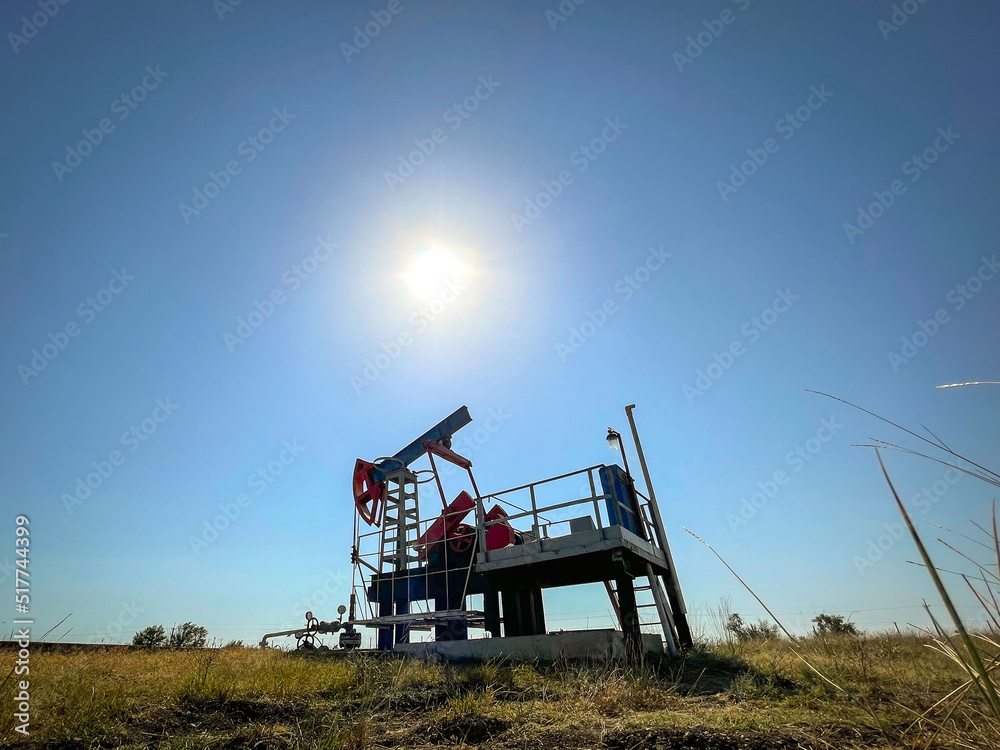 Fototapeta premium Oil producing pump extracts oil from a well