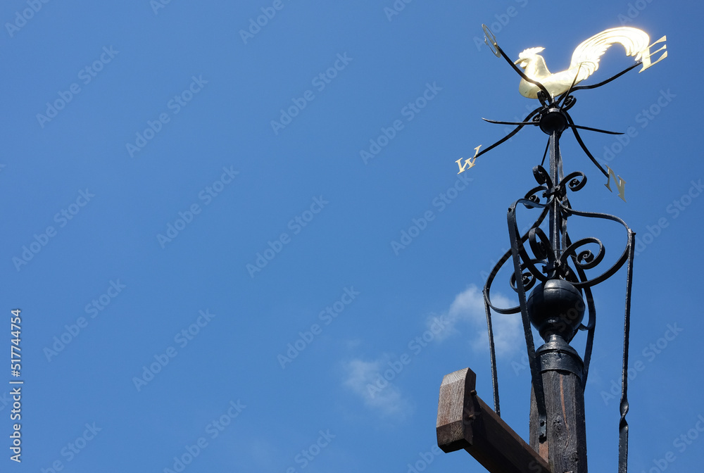 A rooster weathervane under the sky A rooster weathervane under the sky