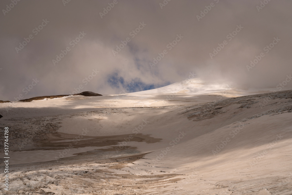 Alpine landscape. High in the Andes cordillera mountains. View of glacier Castaño Overo and Tronador hill under a cloudy sky. Beautiful white snow colors and ice texture.