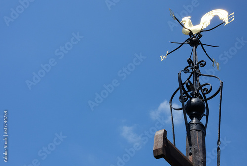 Fotografie, Obraz A rooster weathervane under the sky