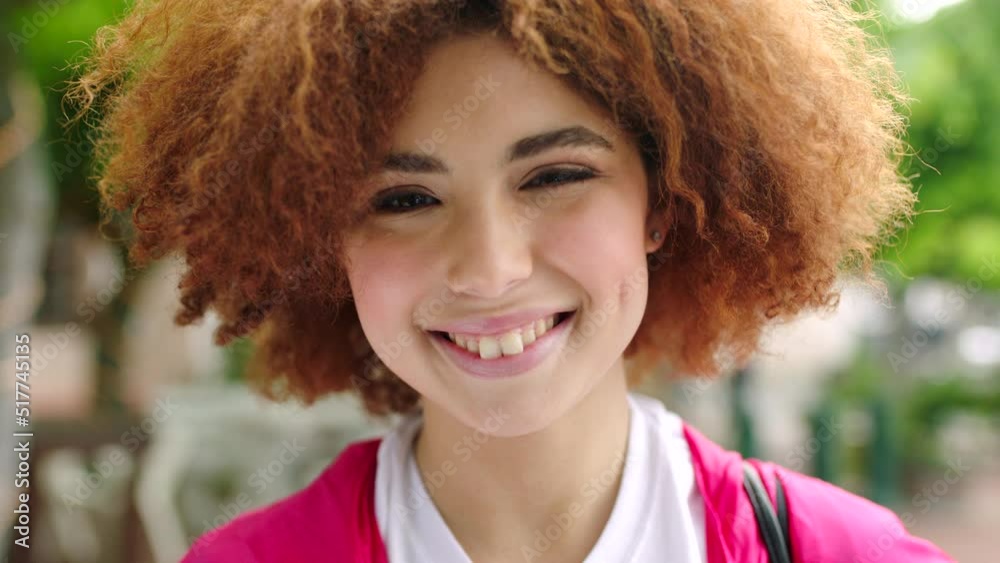 Face portrait of a smiling afro woman showing white teeth after a whitening treatment in city. Closeup headshot of friendly, confident redhead standing alone with a cheerful, joyful facial expression Face portrait of a smiling afro woman showing white teeth after a whitening treatment in city. Closeup headshot of friendly, confident redhead standing alone with a cheerful, joyful facial expression