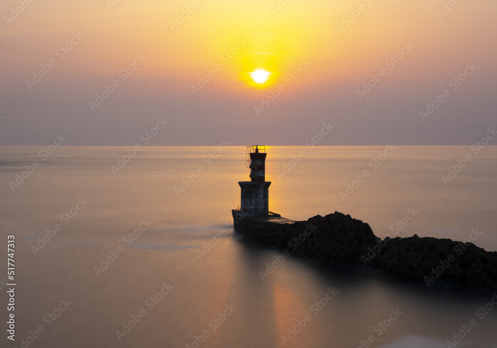 lighthouse and sun at sunset at the exit of the port of Pasaia, Euskadi lighthouse and sun at sunset at the exit of the port of Pasaia, Euskadi