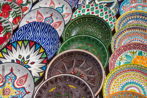 Decorative ceramic plates with traditional uzbek ornament in the street market of Bukhara. Uzbekistan photo