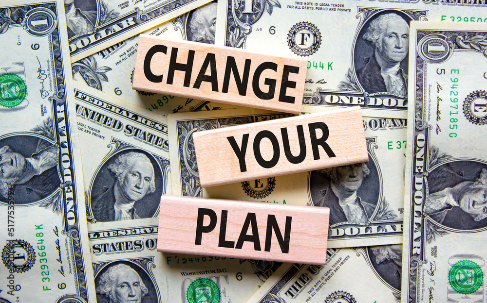 Change your plan symbol. Concept words Change your plan on wooden blocks on a beautiful background from dollar bills. Business, finacial and change your plan concept. Copy space.