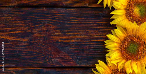 Bright sunflower flowers on an old wooden table. View from above.