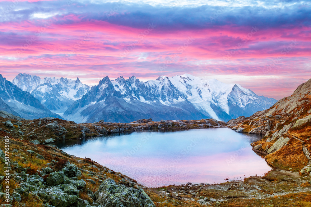 Colourful sunset on Chesery lake (Lac De Cheserys) in France Alps. Monte Bianco mountain range on background. Vallon de Berard Nature Preserve, Chamonix, Graian Alps. Landscape photography