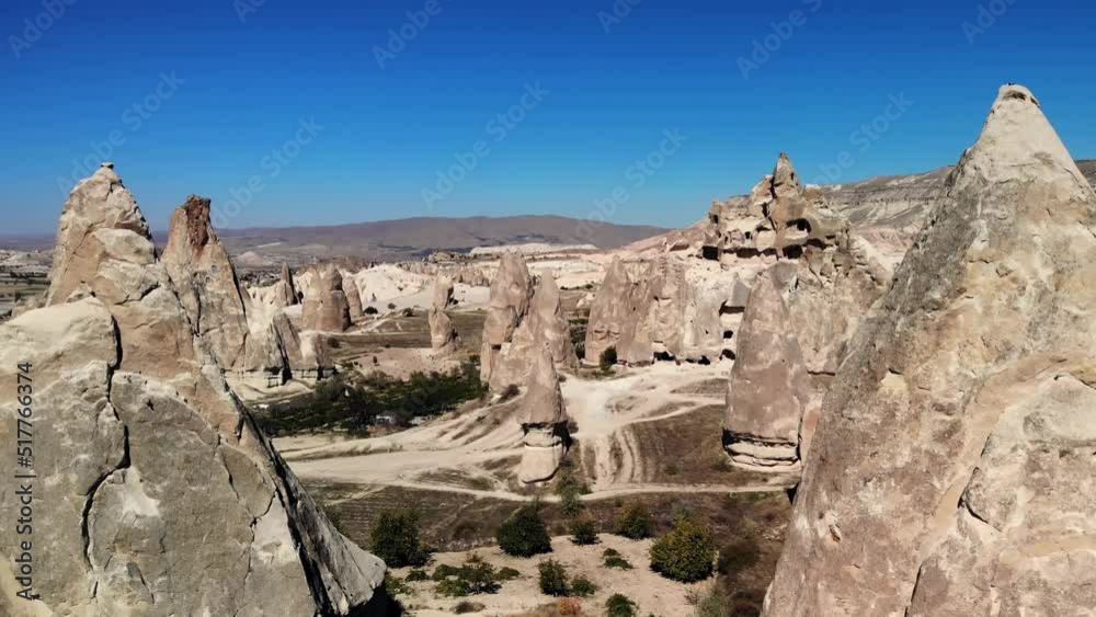 aerial mesmerizing view of natural formations of mountains in Cappadocia, taken from air. Flying past rocks in which you can see valley with cave houses aerial mesmerizing view of natural formations of mountains in Cappadocia, taken from air. Flying past rocks in which you can see valley with cave houses