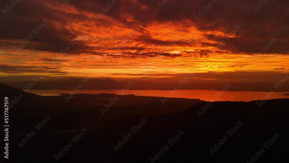 Warm sunset with silhouette of mountains and sea in Florianopolis. Aerial view
