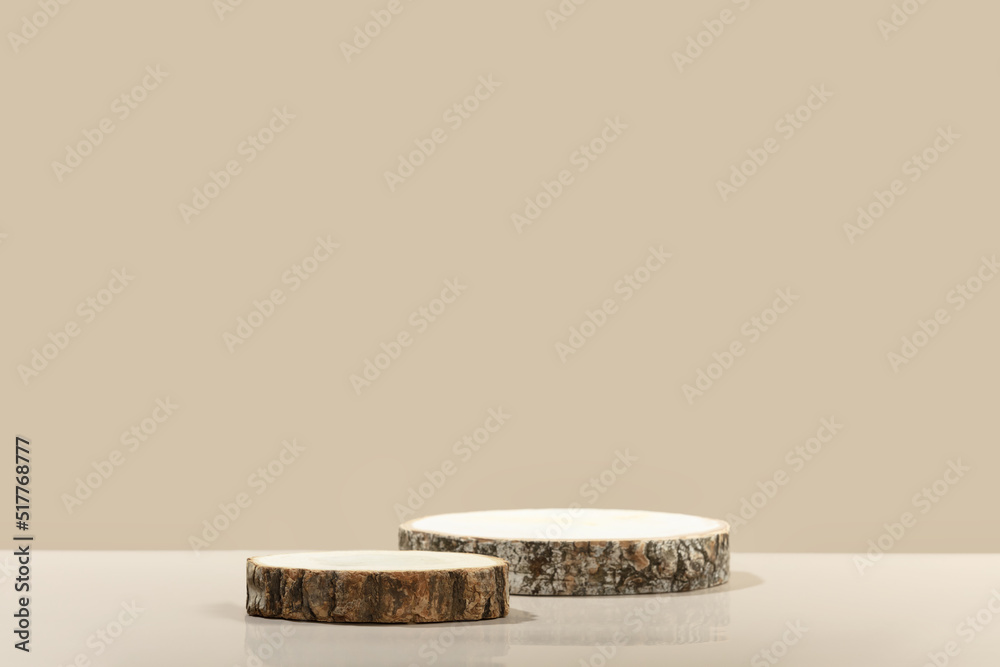 Wood slice podiums on beige background for cosmetic product mockup