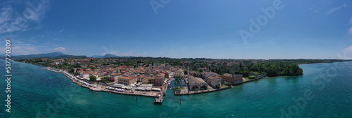 Fototapeta Naklejka Na Ścianę i Meble -  Aerial view of Lazise city, Verona. The historical part of the city of Lazise, coastline. Aerial panorama of Lazise town on Lake Garda Italy.