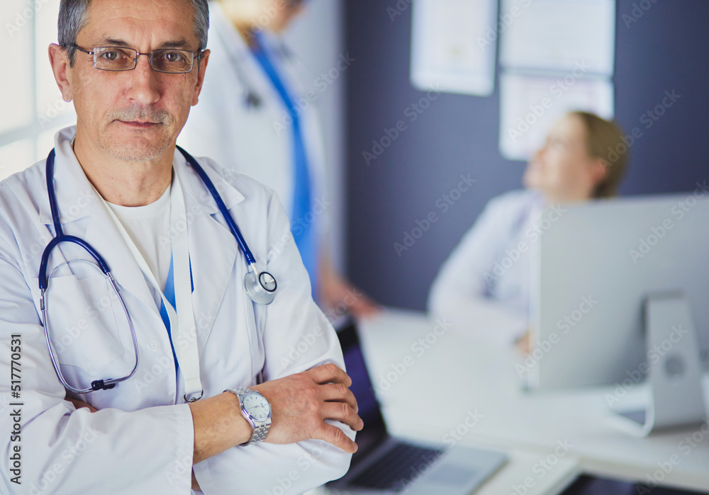 Portrait of a smiling doctor in his bright office Portrait of a smiling doctor in his bright office