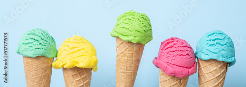 Valokuva Colorful ice cream scoops in cones, bright blue background