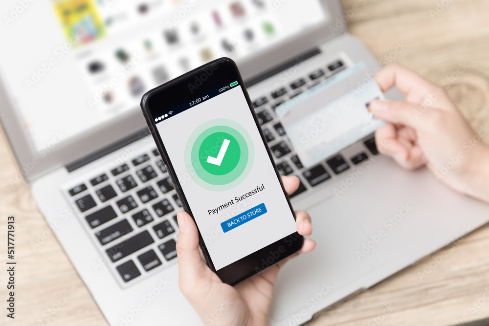 Online shopping concept.Womand hands using mobile phone with payment successful on screen and holding credit card Online shopping concept.Womand hands using mobile phone with payment successful on screen and holding credit card