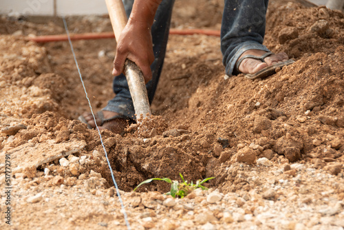 close-up shot of a man's hand digging with a shovel in the ground