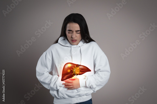 Sick woman suffering from pain and illustration of unhealthy liver on light blue background. Viral hepatitis