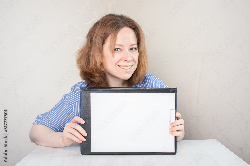woman at table holding empty sheet on clipboard,space for text,mockup woman at table holding empty sheet on clipboard,space for text,mockup