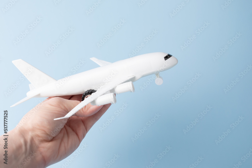 summer vacation, tourism and travel, airline ticket booking, international flights, plane in hand on a blue background summer vacation, tourism and travel, airline ticket booking, international flights, plane in hand on a blue background