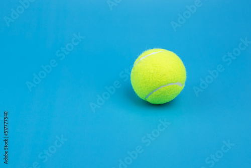 tennis ball on blue background copy space photo