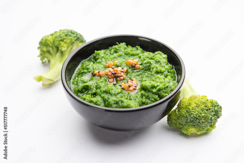 Fresh broccoli chutney or paste, puree in the bowl with raw pieces Fresh broccoli chutney or paste, puree in the bowl with raw pieces