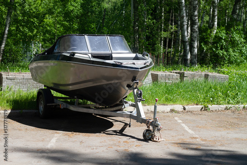 Obraz na płótnie A boat or a boat with a motor on a trailer with wheels for transportation by car with a trailer w salonie