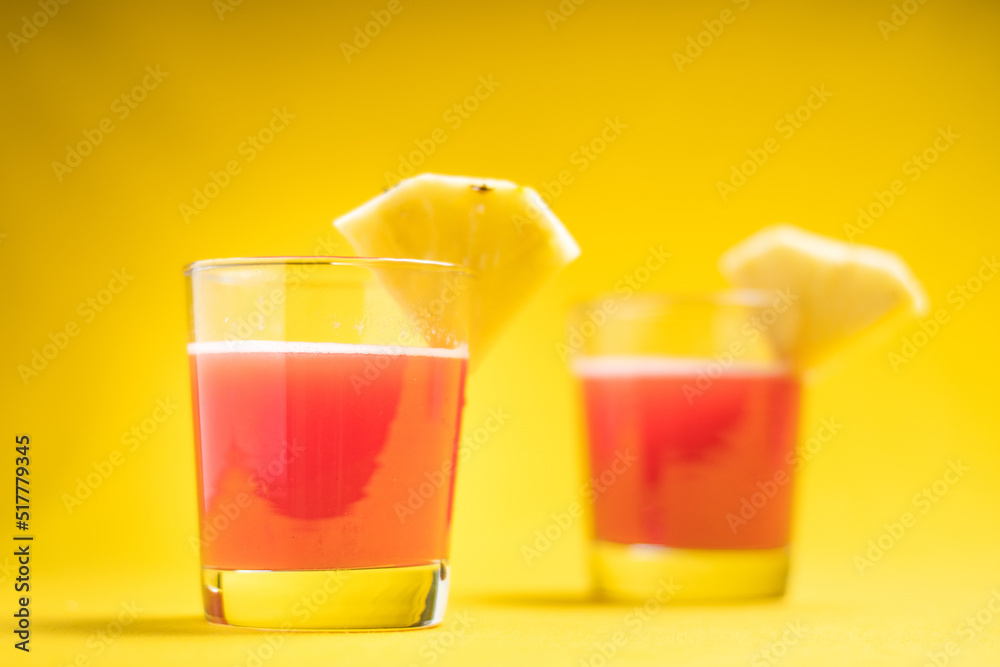 Pineapple juice in glass closeup near sliced fruit with spash and dripping liqid for summer vibes. Pineapple juice in glass closeup near sliced fruit with spash and dripping liqid for summer vibes.