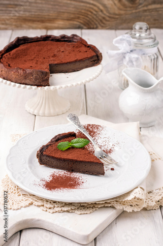 Traditional French tarte au chocolat cake served as close-up on a classic white plate photo