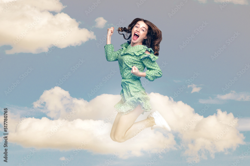 Delighted amazed girl flying mid-air with raised fists shouting for joy jumping trampoline looking at camera extremely happy, celebrating success in the sky. collage composition on day cloudy blue sky Delighted amazed girl flying mid-air with raised fists shouting for joy jumping trampoline looking at camera extremely happy, celebrating success in the sky. collage composition on day cloudy blue sky