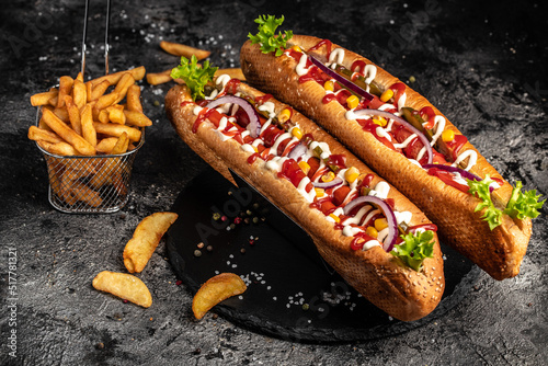 Hot dogs with different toppings on a dark background. Food background. fast food and junk food concept, Street food