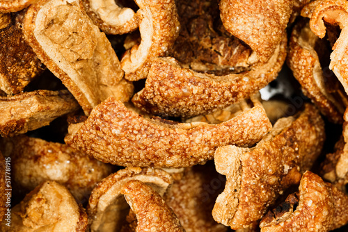 Close up of tasty pork cracklings or pork rinds. Crispy fried pig skin