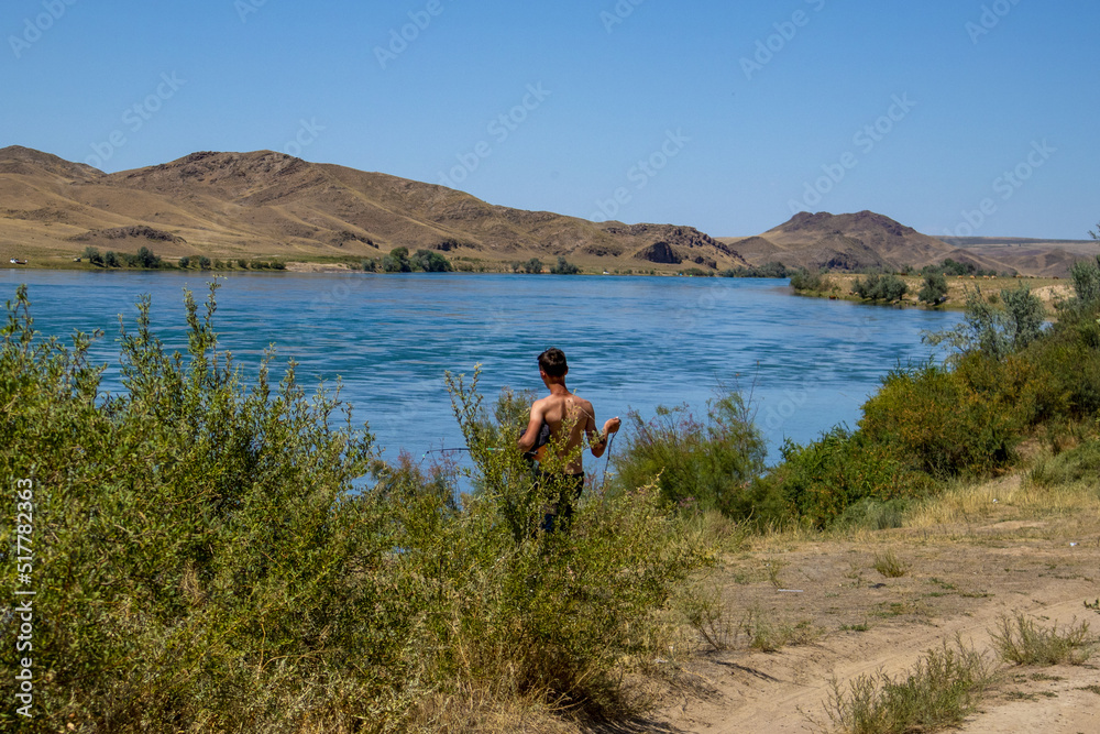 beautiful mountain and water landscape. azure water. the guy goes fishing