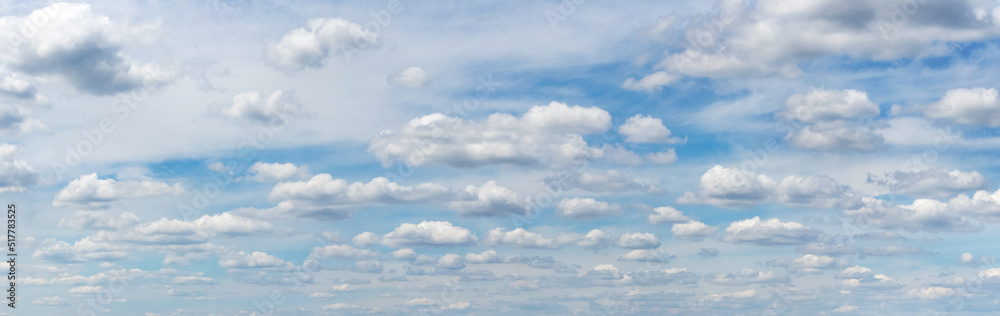 White small curly clouds in the blue sky White small curly clouds in the blue sky