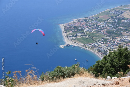 Paraglider flying on Oren beach in Milas, Mugla. Travel destination. Summer and holiday concept.