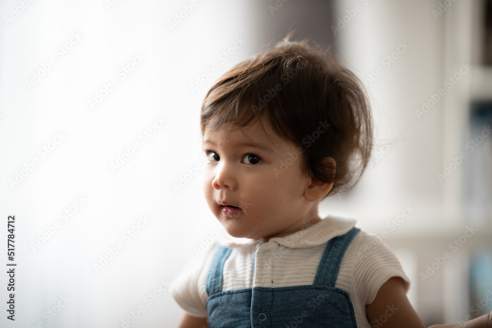 Cute little toddler holding toy while sitting on floor with stuff toy playing with father at home Cute little toddler holding toy while sitting on floor with stuff toy playing with father at home