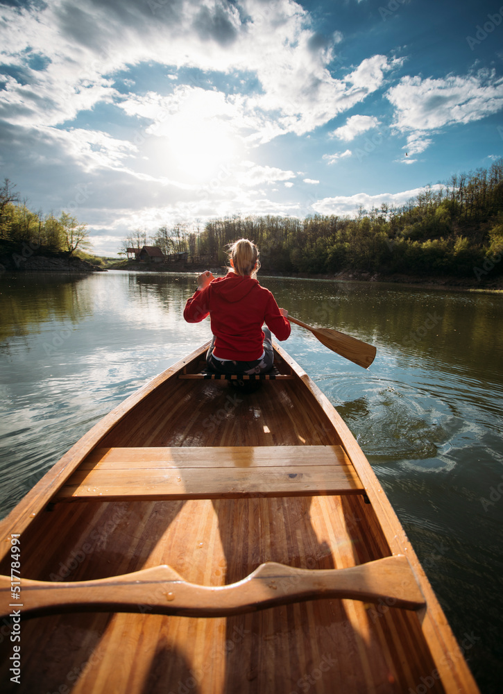 Woman paddling canoe on the lake Woman paddling canoe on the lake