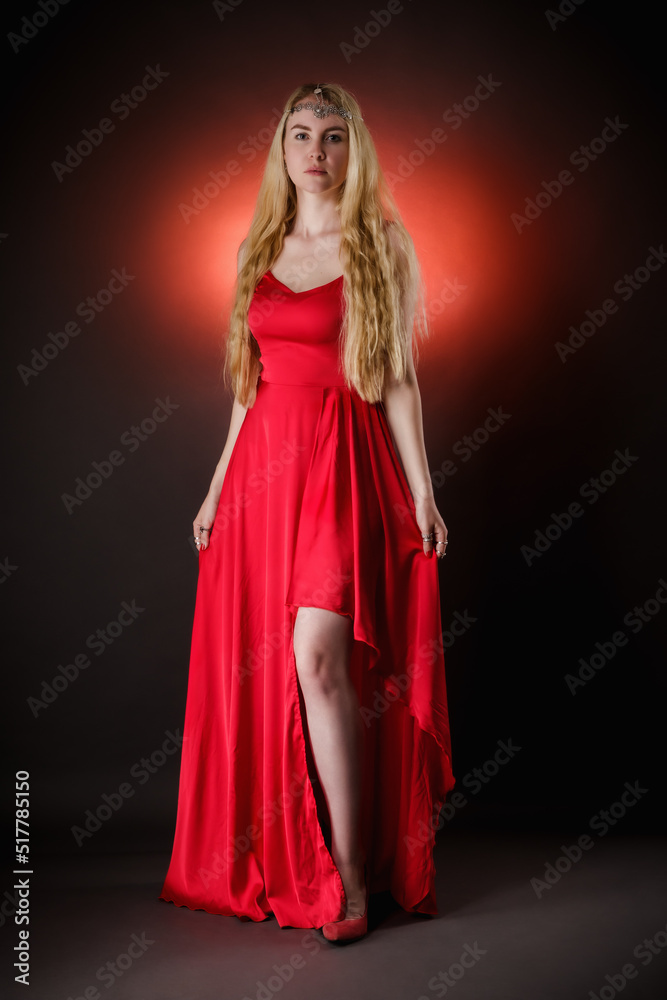 An angel girl with long white hair in a long red dress and a bright red flash behind her, as if inspiring her and giving her wings An angel girl with long white hair in a long red dress and a bright red flash behind her, as if inspiring her and giving her wings