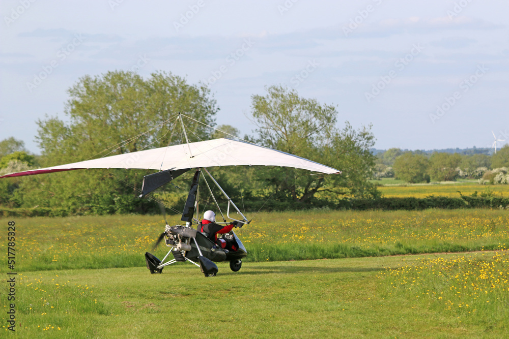 Ultralight airplane taxiing on a farm strip Ultralight airplane taxiing on a farm strip