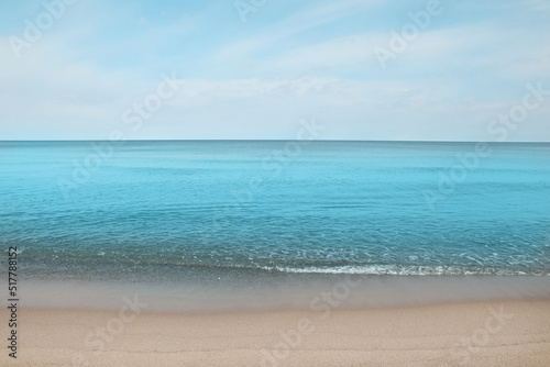 Beautiful view of sea shore under blue sky on sunny day