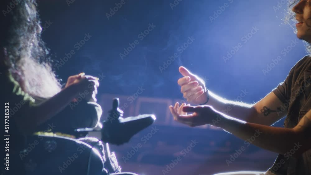 During a rehearsal of a romantic performance with a director, an actor on his knees singing a song to a disabled actress on a stage illuminated by a spotlight During a rehearsal of a romantic performance with a director, an actor on his knees singing a song to a disabled actress on a stage illuminated by a spotlight