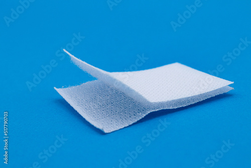 Foto Hook-and-loop fastener white Velcro in closeup on blue background