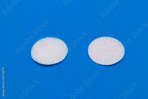 Foto Hook-and-loop fastener white Velcro in closeup on blue background