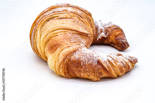 croissant with powdered sugar on white background