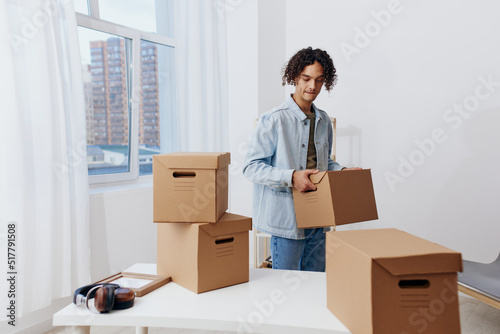 portrait of a man unpacking things from boxes in the room Lifestyle © SHOTPRIME STUDIO