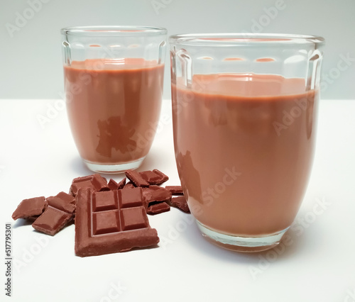 glass of chocolate beverage and chocolate bar