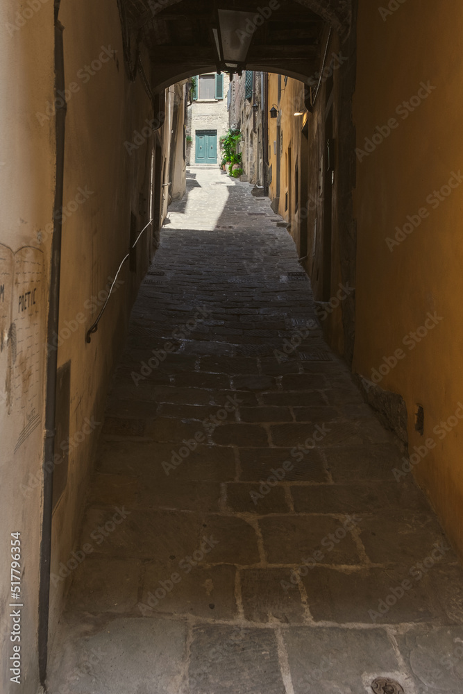 Arch on narrow street on a sunny summer day